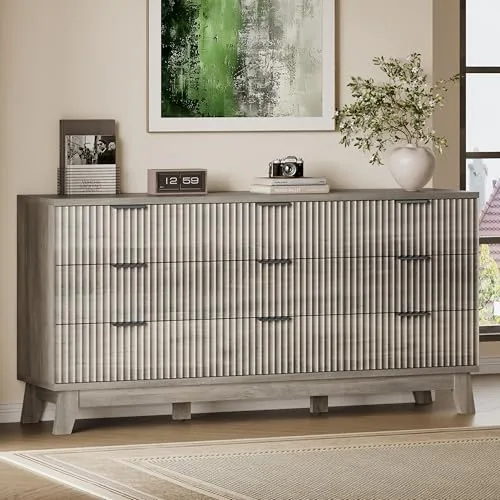 Extra-wide fluted chest of drawers standing below a round mirror