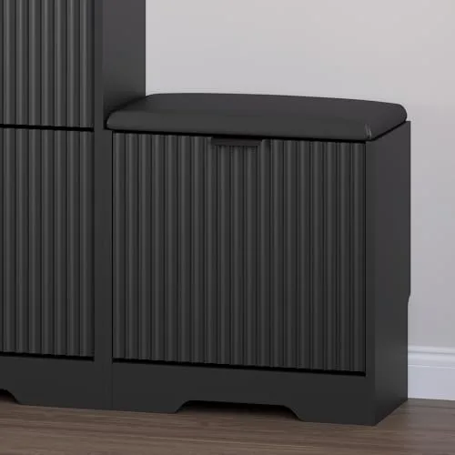 A black BORNOON shoe cabinet with a deeply reeded front and a seat pad on top